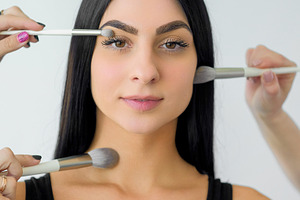 Cosmetic model applying powder face skin makeup, a Person Photo by Photo Drive Studio