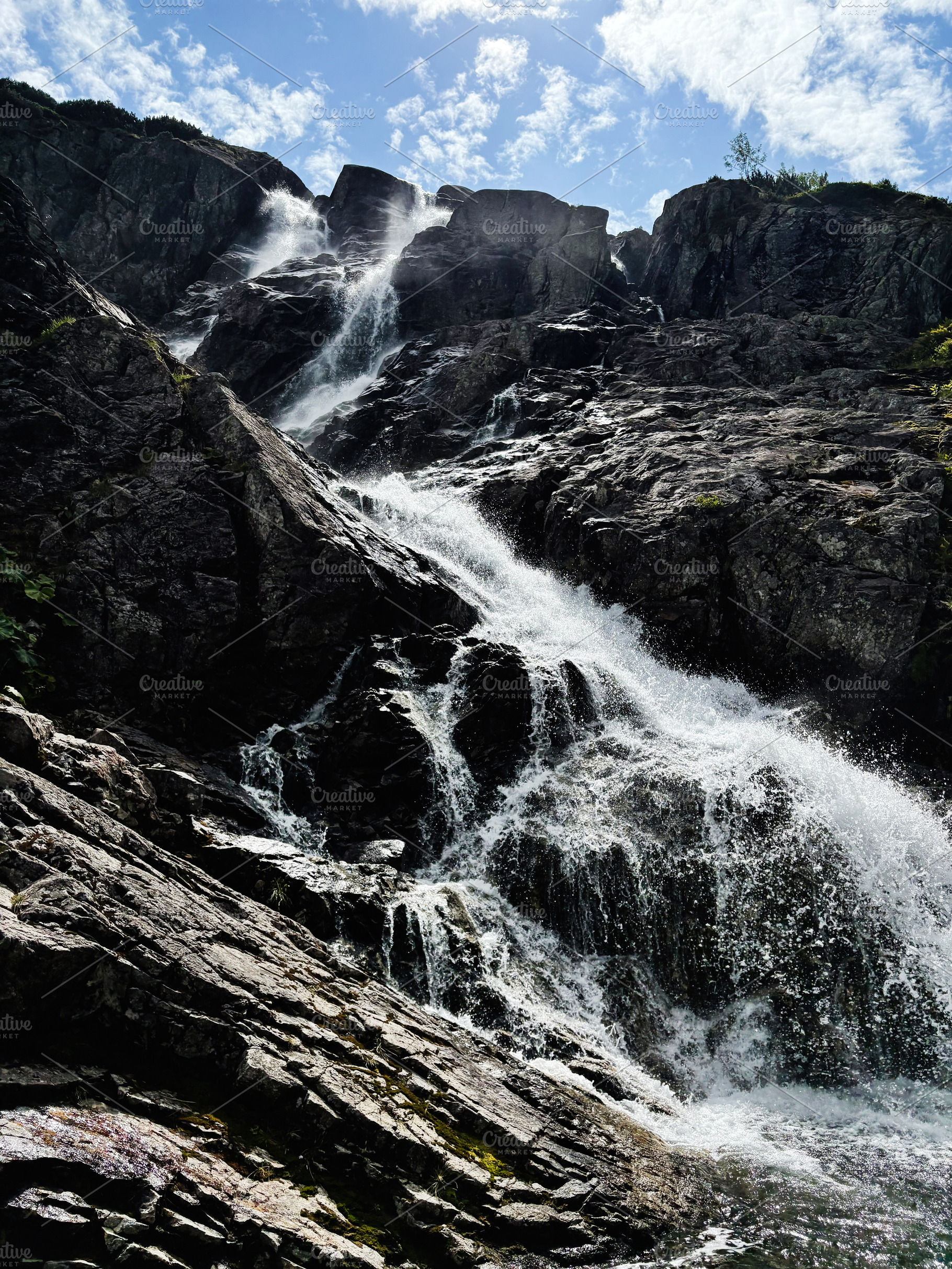 Waterfall cascade over rugged rocks in Zakopane Poland a dramatic natural scene, a Nature Photo by AS photostudio