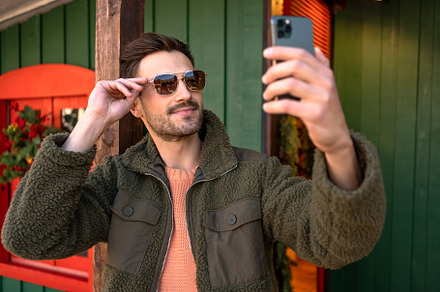 Handsome young man taking self portrait, a Person Photo by andreonegin market