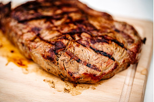 Close up of steak from grill on, a Food & Drink Photo by HalfPoint