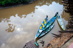Canoes on the calm waters of Cuyabeno Reserve, Ecuador, a Photo by GoodGoods