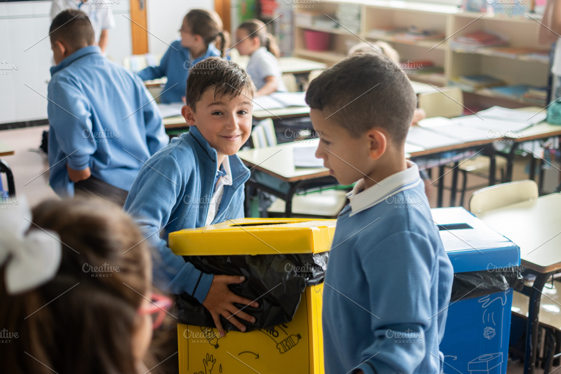 Elementary school children recycling waste together in classroom, a Person Photo by etorres69
