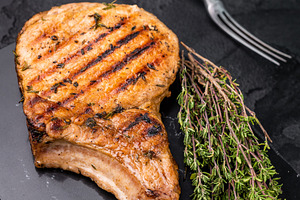 Savory bone in pork chop steak, beautifully charred and ready to, a Food & Drink Photo by composter-box@mail.ru