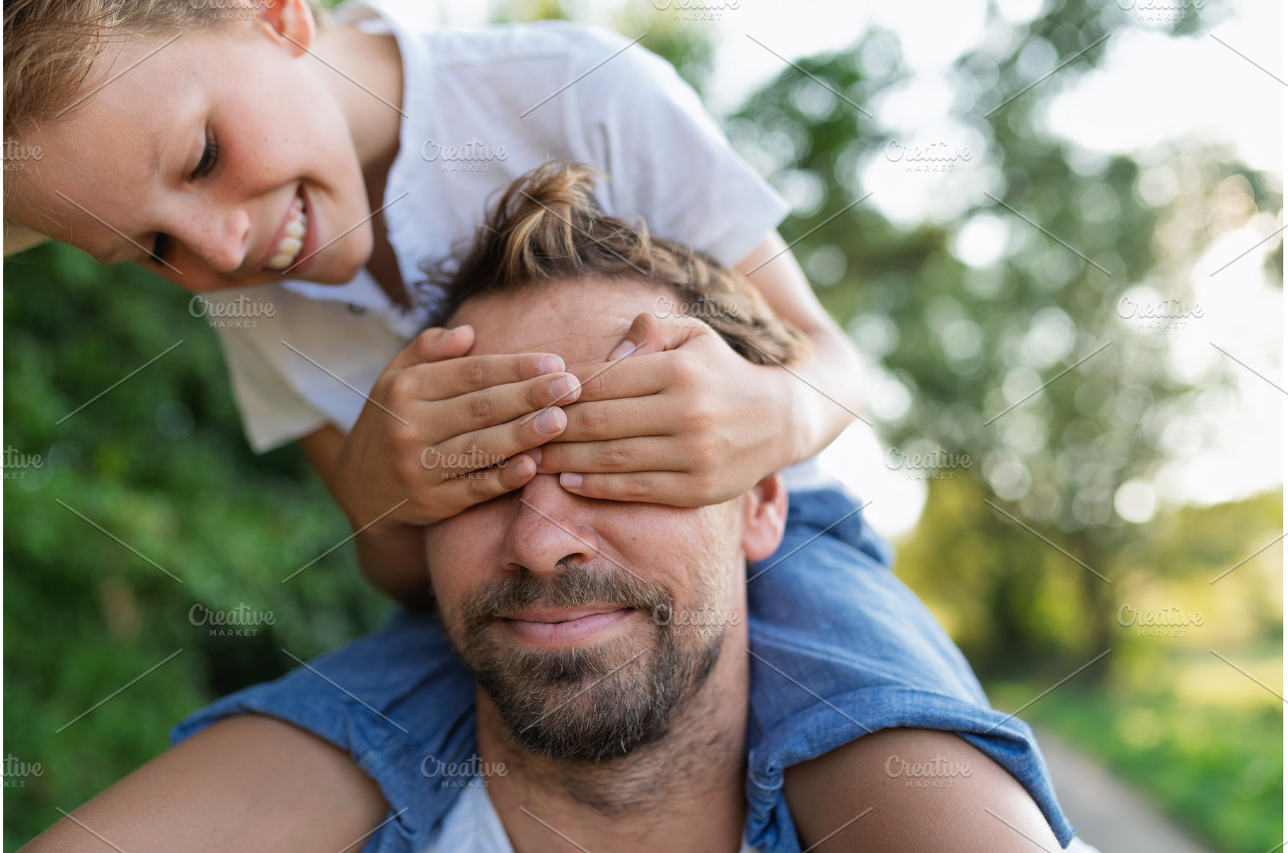 Happy child covering father's eyes, a Person Photo by HalfPoint
