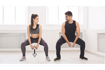 Muscular coach showing girl how to, a Sports & Recreation Photo by Prostock-Studio