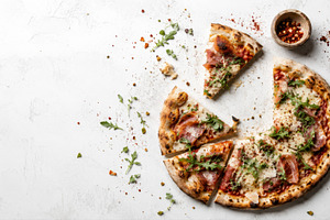 Topped pizza on a table, a Photo by Beautiful things