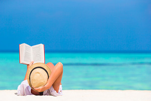 Young woman reading book during tropical white beach containing beach, read