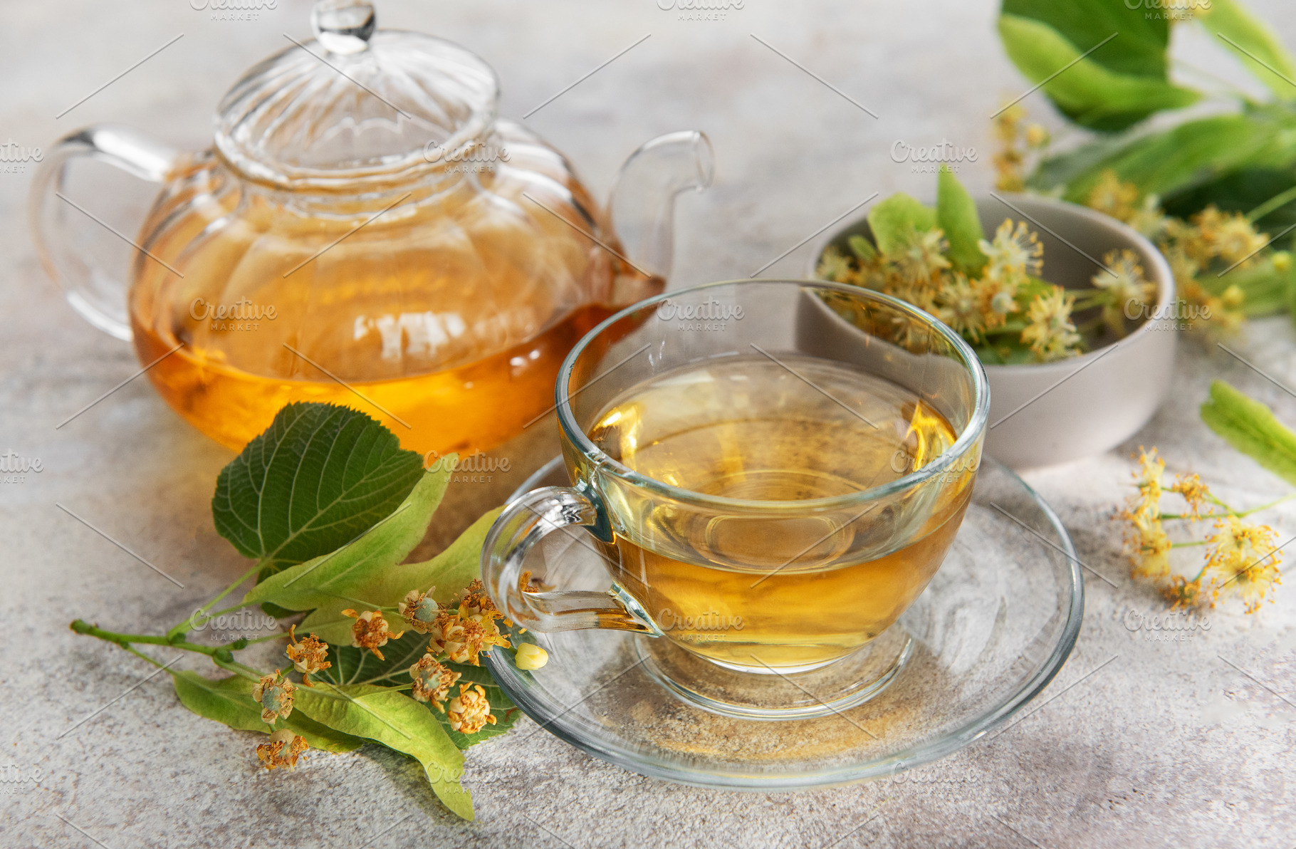 Linden tea brewing in glass teapot with cup, a Food & Drink Photo by Olena Rudo