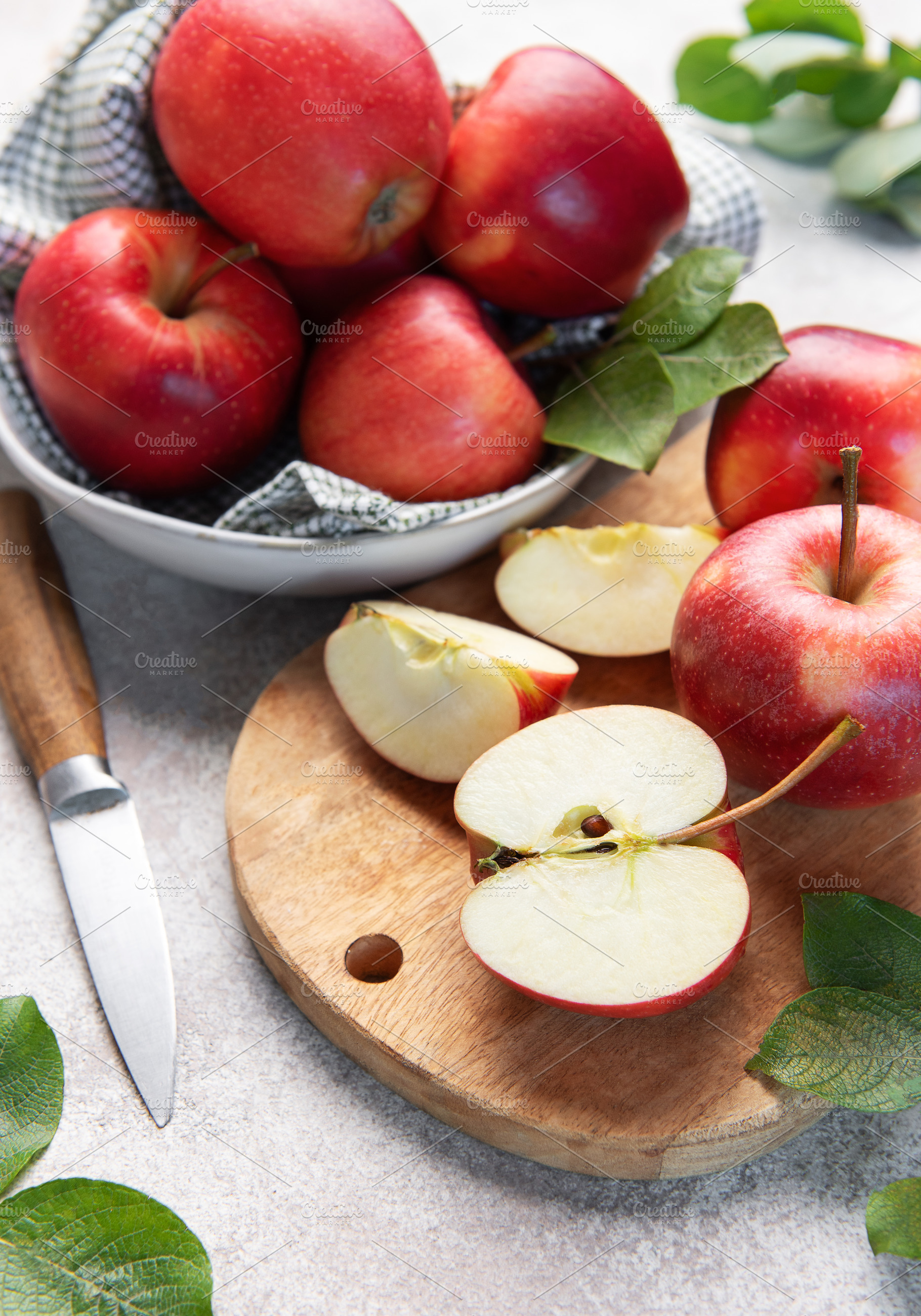 Red apples, whole and sliced, on cutting board, a Food & Drink Photo by Olena Rudo
