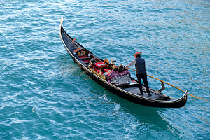Gondolier in gondola in Venice, a Transportation Photo by BOOCYS