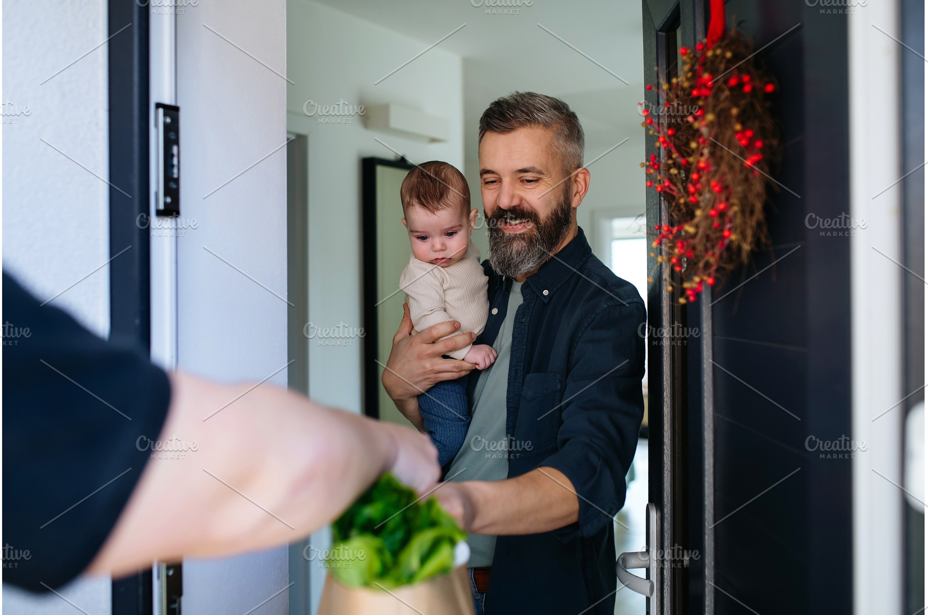 Father holding a baby in his arms, a Food & Drink Photo by HalfPoint