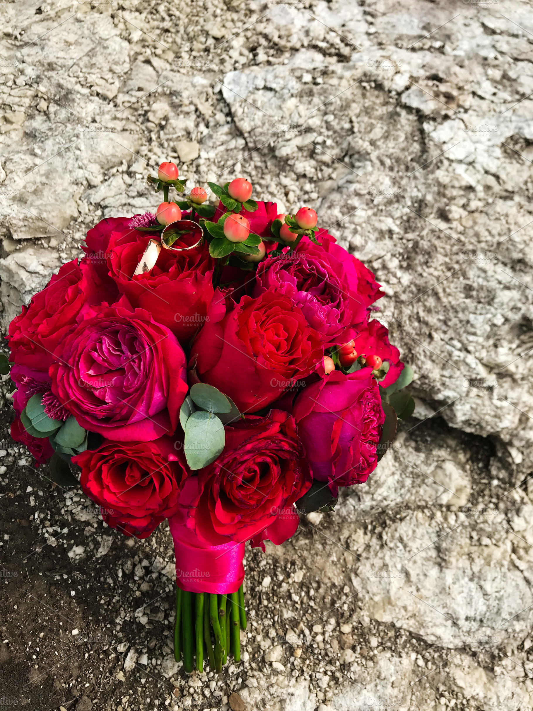 Elegant bridal bouquet with red roses and wedding rings, a Photo by AS photostudio