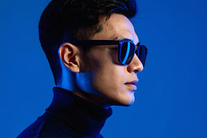 Businessman in black turtleneck posing with sunglasses profile, a Nature Photo by GoodGoods