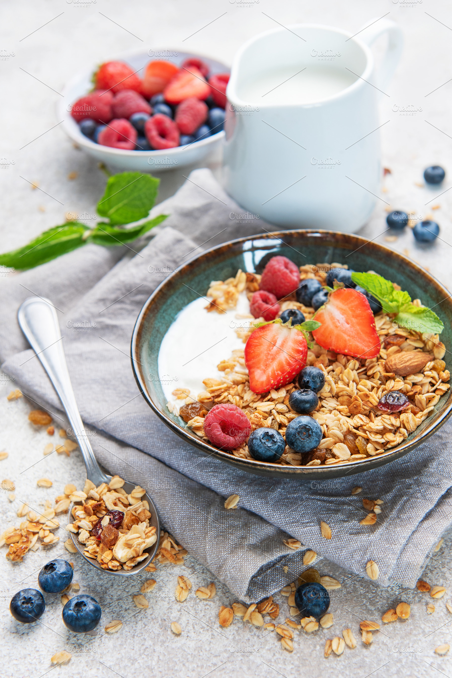 Granola bowls with berries, yogurt, nuts, and honey for breakfas, a Food & Drink Photo by Olena Rudo