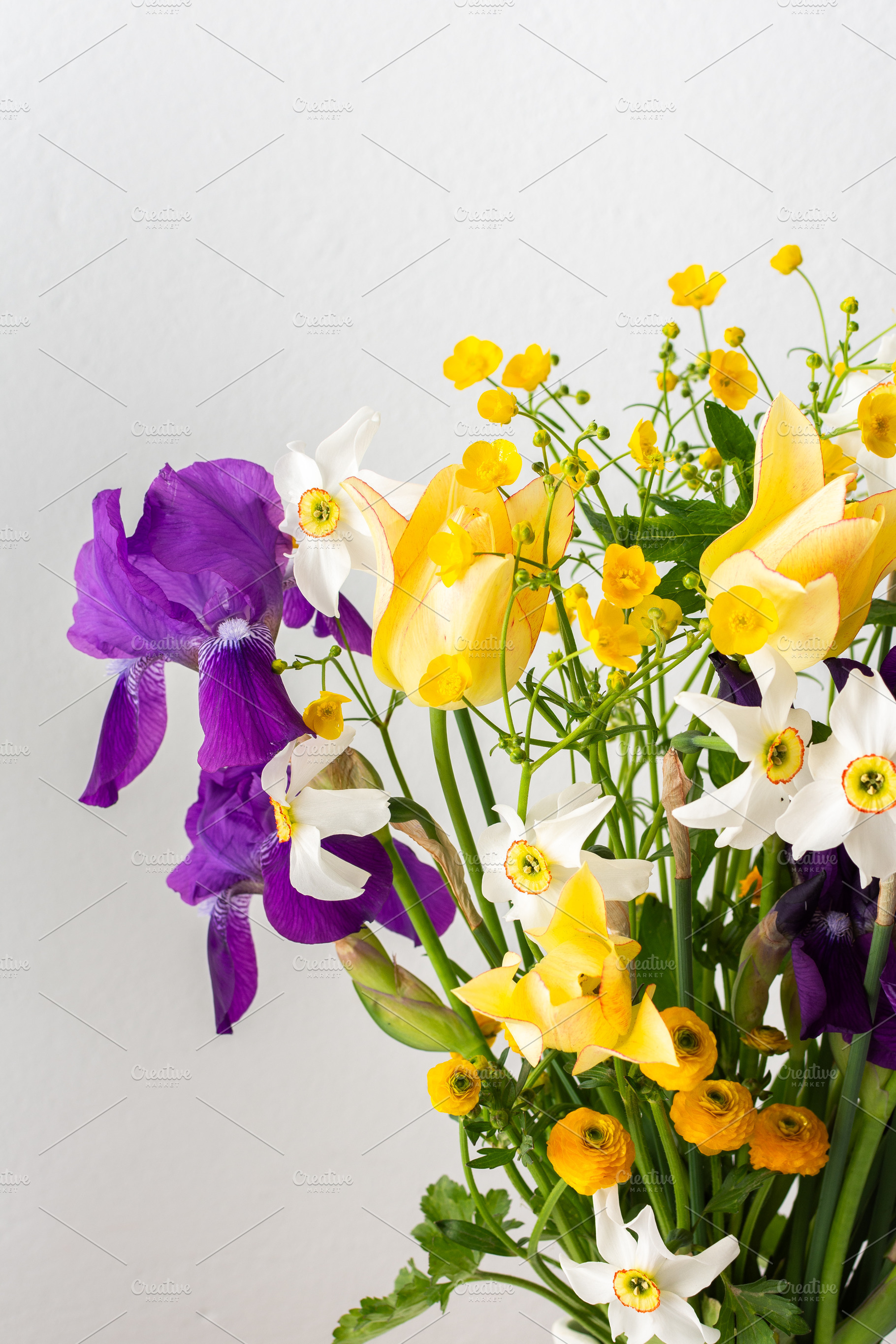 Irises and yellow ranunculus, a Nature Photo by Pundateam