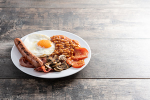 Full English breakfast with fried egg, bacon, sausages and beans, a Food & Drink Photo by etorres69