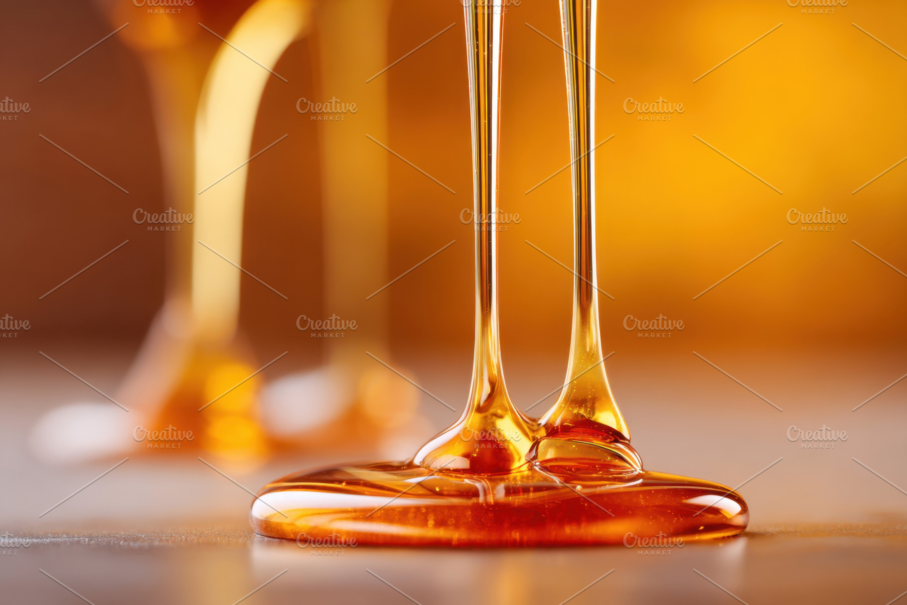 Golden honey dripping close-up, a Background Photo by AlyaAnd
