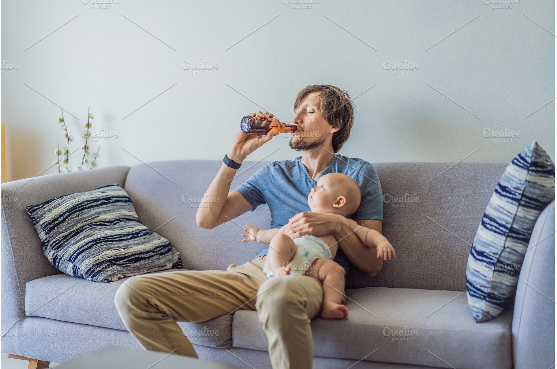 Stressed father sitting on couch, a Sports & Recreation Photo by Elizaveta Galitskaya