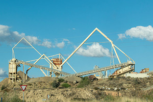 Industrial mining plant in a rocky quarry, an Industrial Photo by DanFLCreativo
