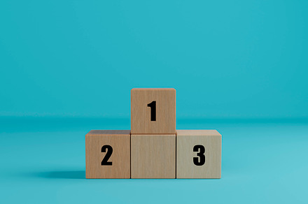Wooden cubes as podium stand with first, second and third place.