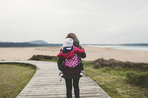 Mother carrying her child stock photo containing baby and family