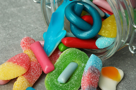 Jar with gummy candies on gray textured background, a Food & Drink Photo by AtlasStudio PRO