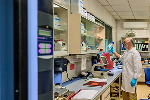 Scientist inspecting flask in a mode, a Health & Medical Photo by Perpis