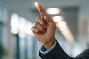 A close-up of a man's hand pointing upward, suggesting an idea or inspiration,, a Person Photo by ImageMir
