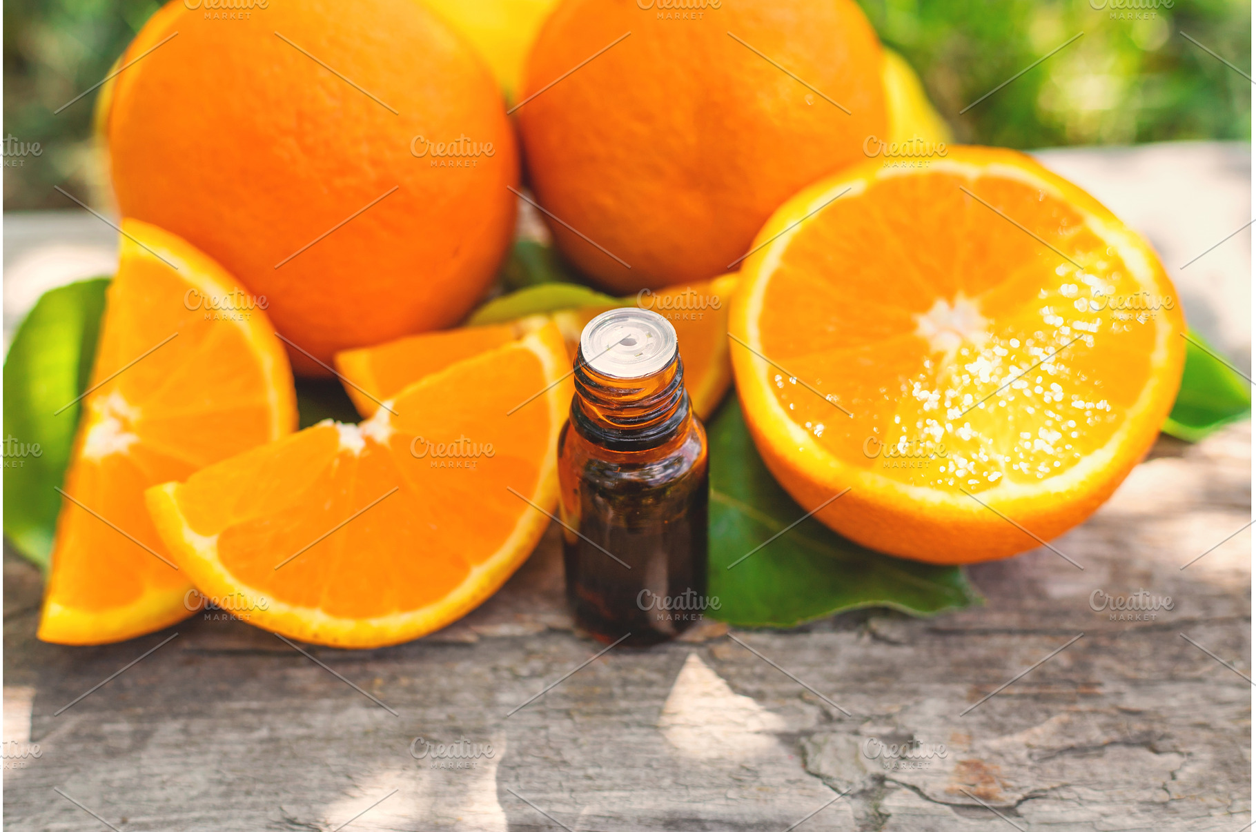orange essential oil in a bottle, a Beauty & Fashion Photo by yanadjana