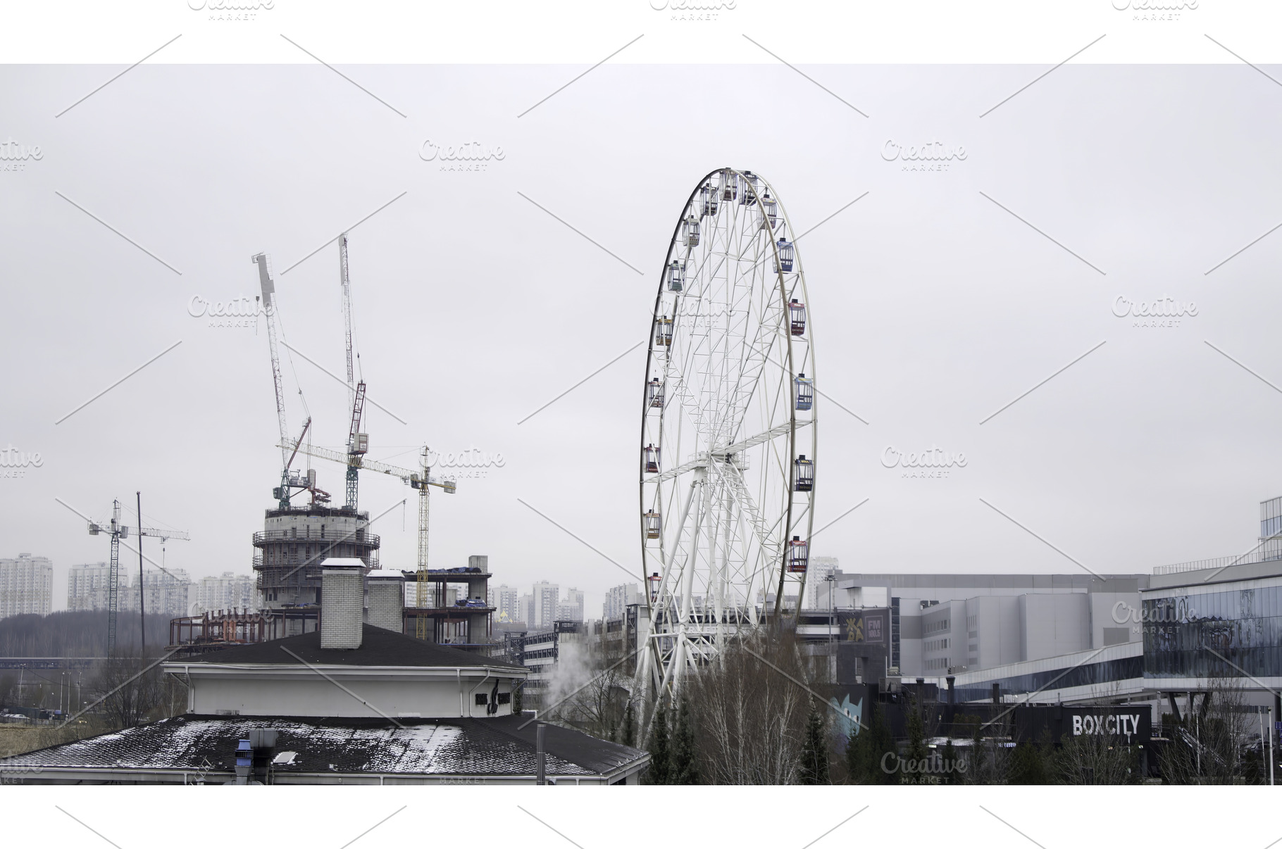 Ferris wheel rotating near, an Architecture Photo by Media Whale Stock