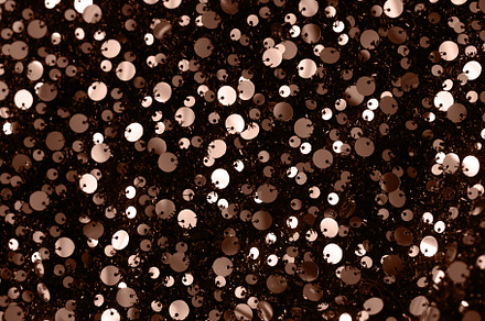 Abstract texture background with sequins. Color of the Year 2025 Mocha Mousse c