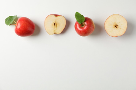 Flat lay with red apples on white background, space for text, a Food & Drink Photo by AtlasStudio