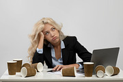 Exhausted woman office employee sitting at workplace surrounded by coffee cups,, a Photo by Prostock-Studio (Thumbnail 2 of 2)
