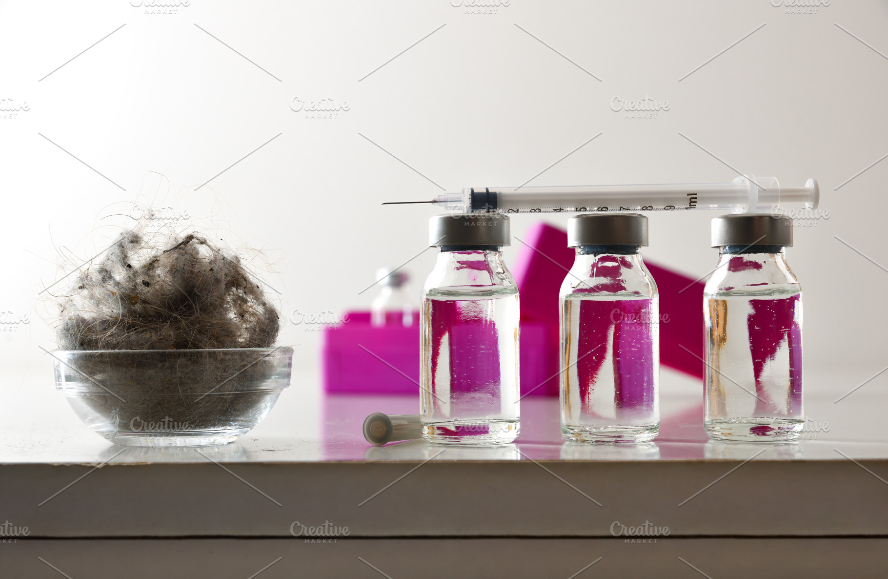 Concept of vaccination against mites with a syringe over vials, a Health & Medical Photo by Davizro's Market