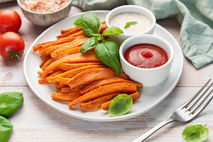 Sweet potato fries with ketchup and dipping sauce, a Food & Drink Photo by Olena Rudo