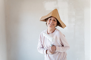 Senior woman painting walls with, a Person Photo by HalfPoint