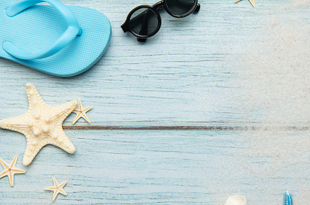 Summer beach essentials on wooden background