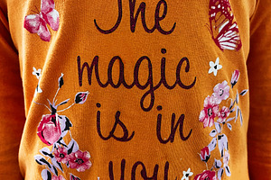 Orange shirt with motivational text The Magic Is In You surrounded by flowers a, a Photo by AS photostudio
