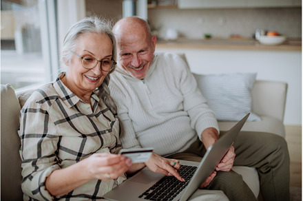 Senior couple sitting on sofa and, a Person Photo by HalfPoint
