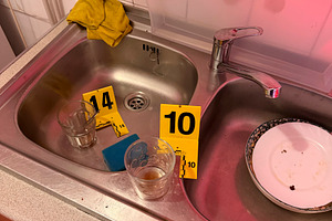 Investigating crime scene evidence in kitchen sink