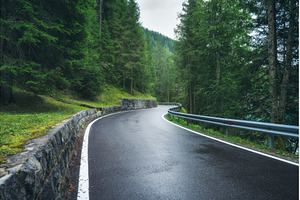 Wet mountain road curving through, a Transportation Photo by den-belitsky