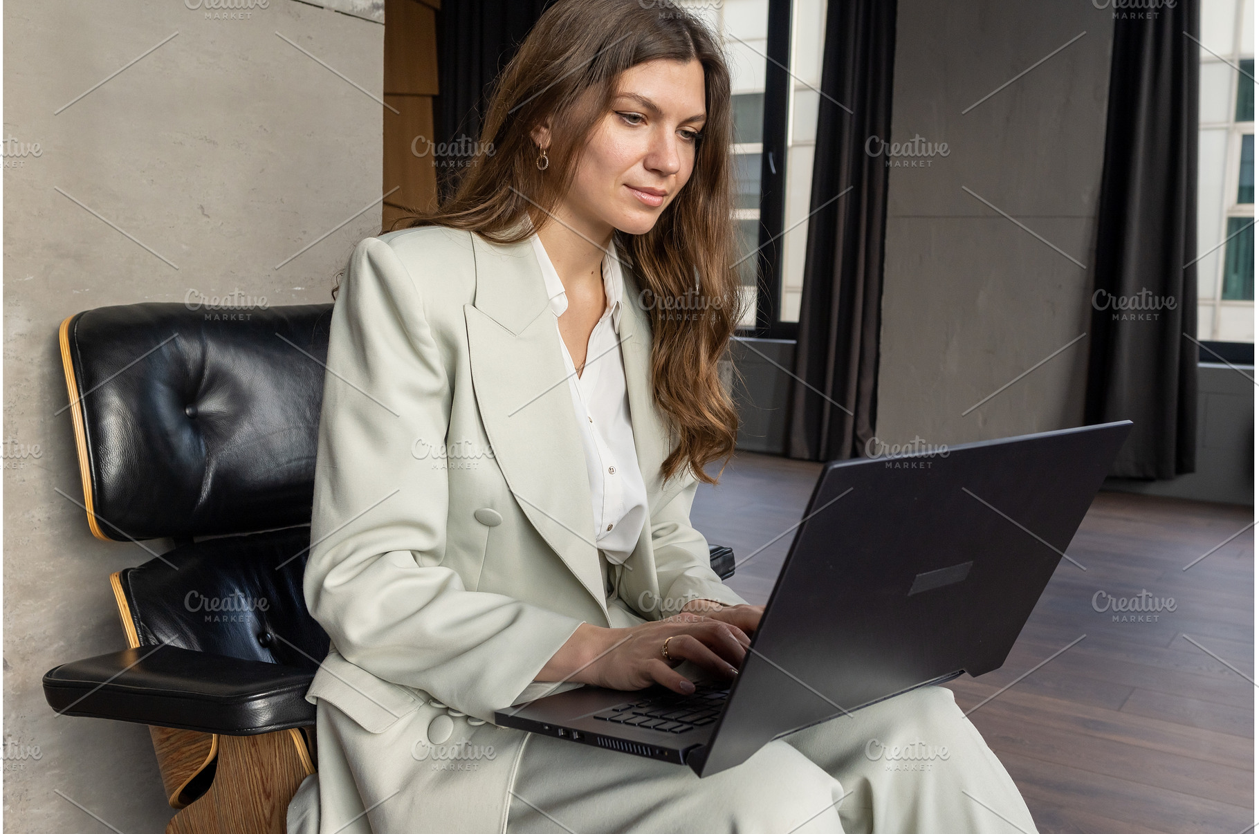 Female businesswomen seated in, a Person Photo by undrey