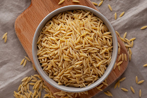 Organic Dried Orzo Pasta in a Bowl, top view. Close-up., a Food & Drink Photo by LiudmylaChuhunova