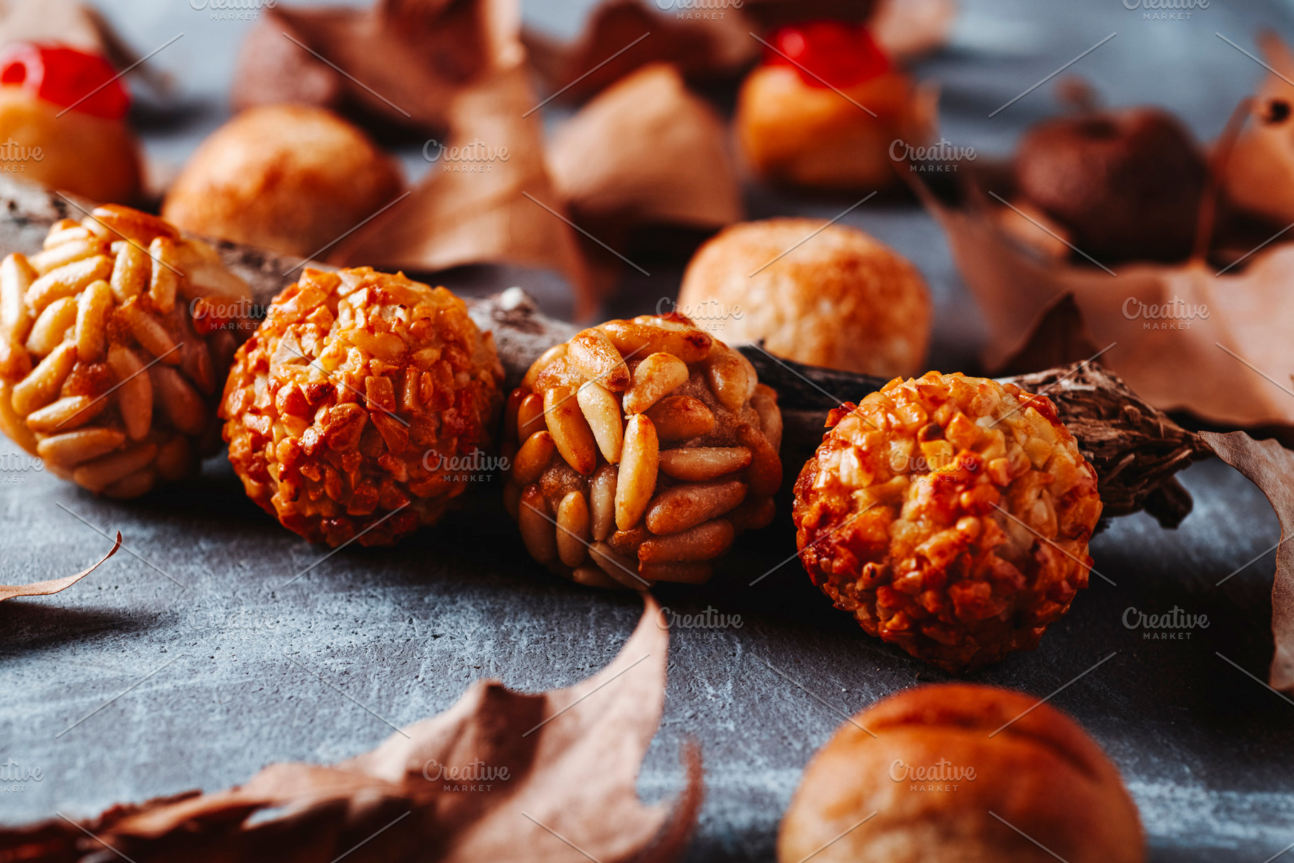 row of Catalan panellets on rustic gray surface, a Photo by Nito