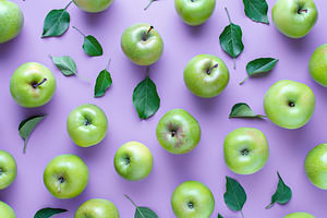 Pattern of fresh apple pieces on purple background, a Food & Drink Photo by AlyaAnd