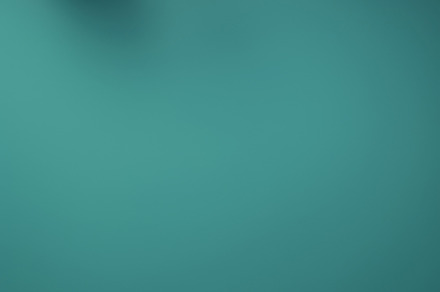 Christmas red and green matte ornaments on teal green background, a Photo by Dvoevnore photos
