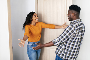African Woman And Man Stretching Hands For Hug Meeting Indoors, a Photo by Prostock-Studio