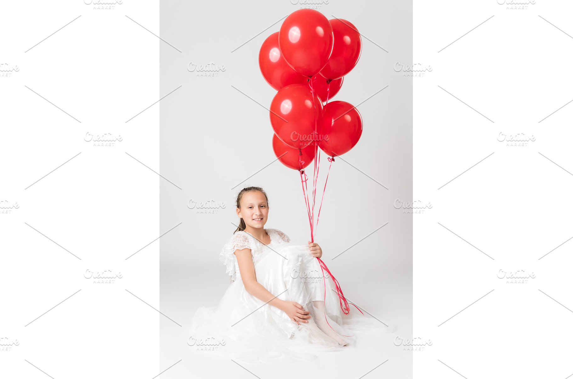 Smiling girl in white dress holding, a Person Photo by Alexander-Piragis