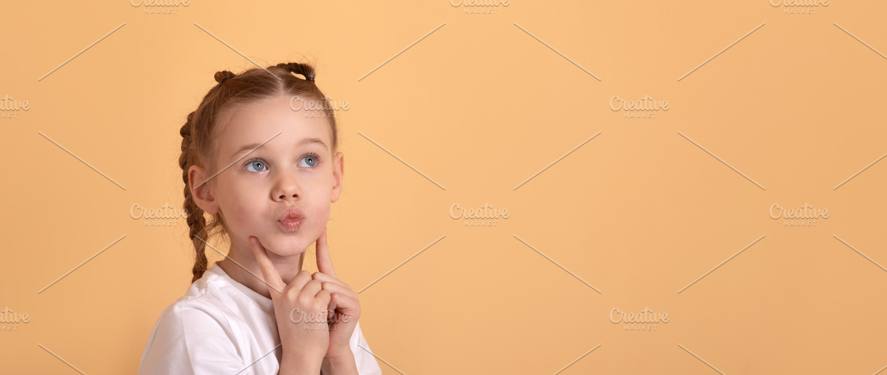 Curious young girl with pigtails in white shirt thinking and loo, a Person Photo by Ales Munt