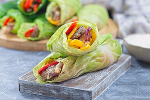 Beef and vegetable cabbage leaves wraps, served with plain yogurt, horizontal, a Food & Drink Photo by iuliia_n